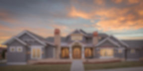 A large custom Colorado home at dusk with a freshly finished architectural roof.
